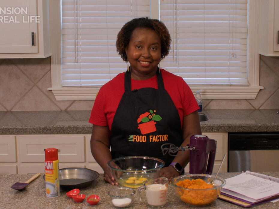 A woman at a kitchen counter with ingredients for a pie.