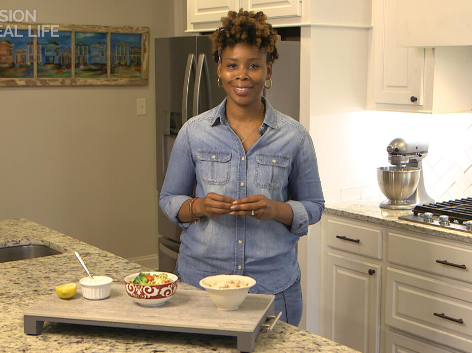 A lady stands in a kitchen.