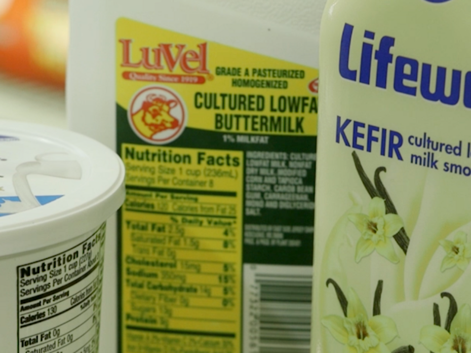 A product display of Greek yogurt, buttermilk and kefir.