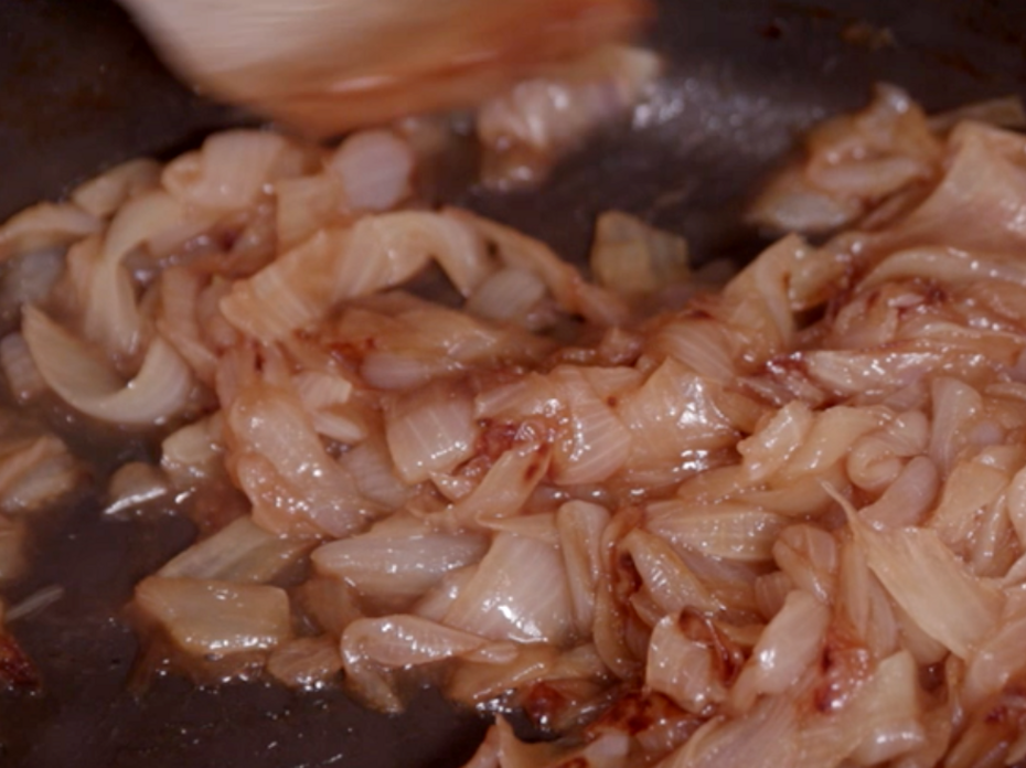 Caramelized onions in a black cast iron skillet.