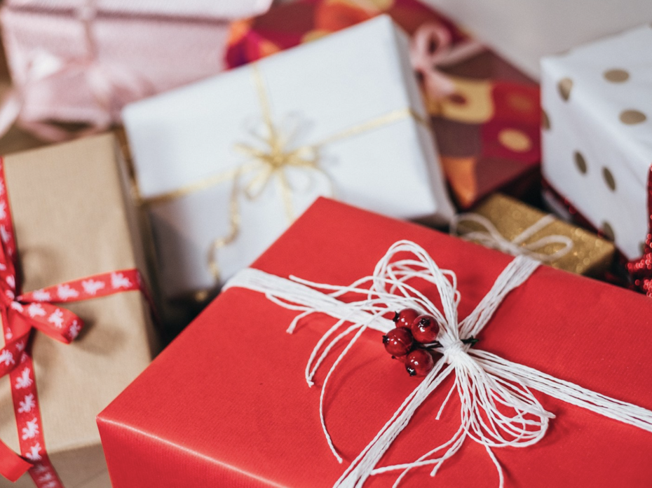 A pile of gifts wrapped in various papers and ribbons.