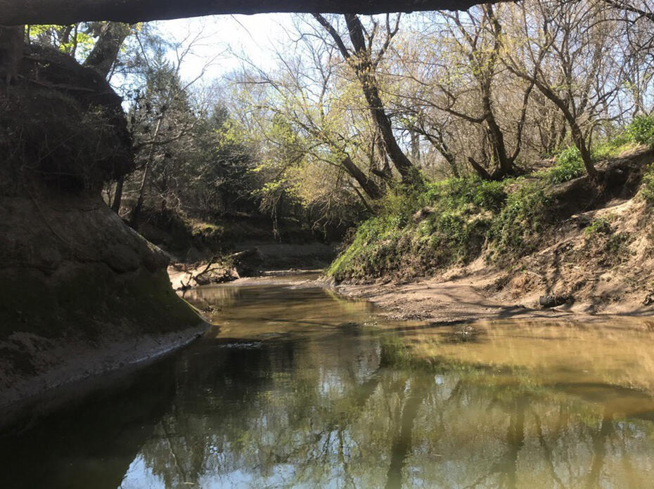 A shallow creek between two hills.