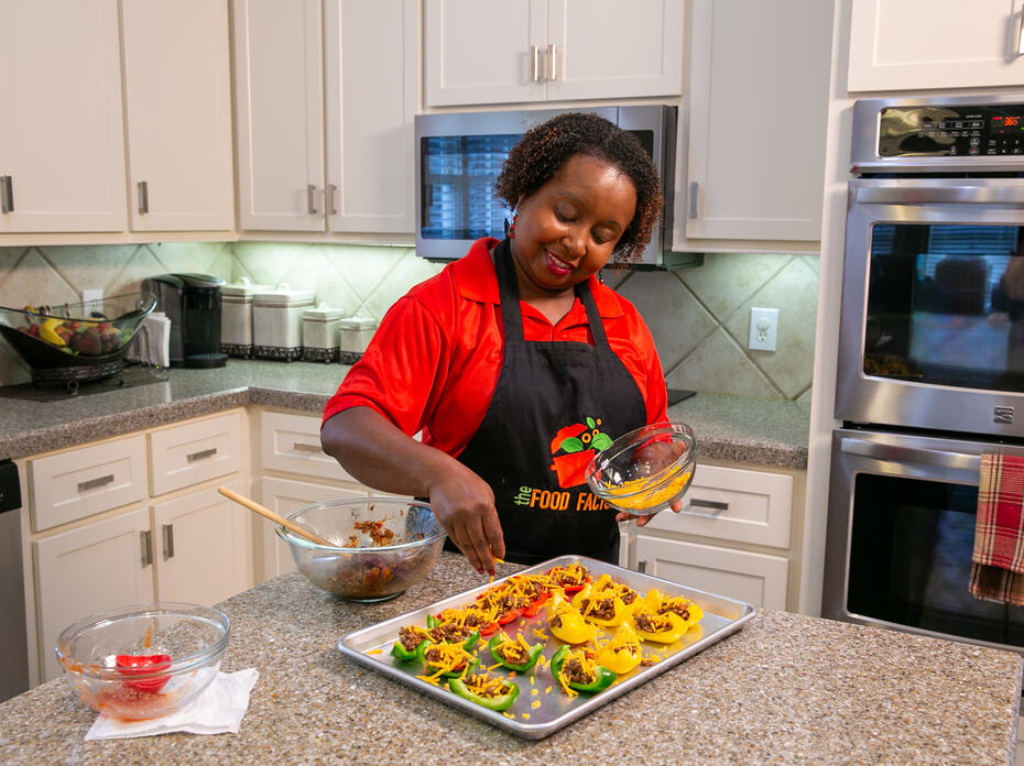 A woman prepares Bell Pepper Nachos in a kitchen.