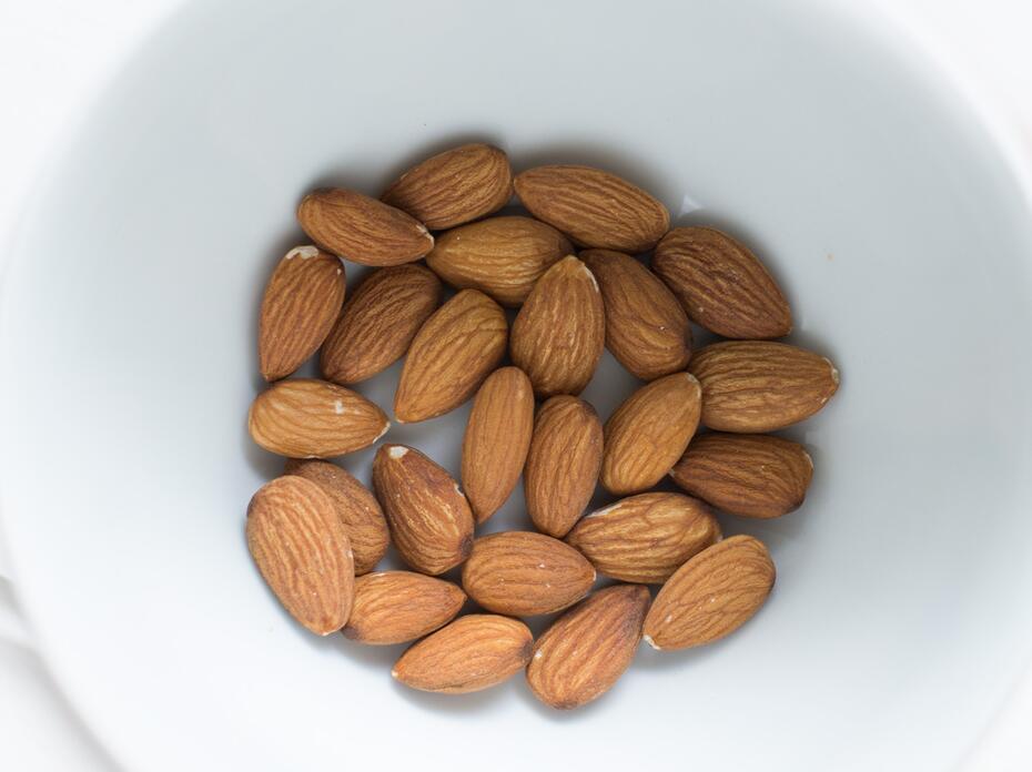 Almonds in a white bowl.