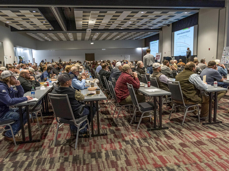A large room full of people watching a presentation.