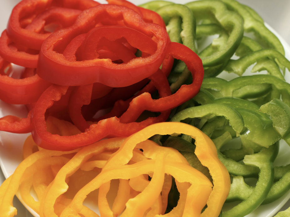 Sliced red, yellow and green bell peppers
