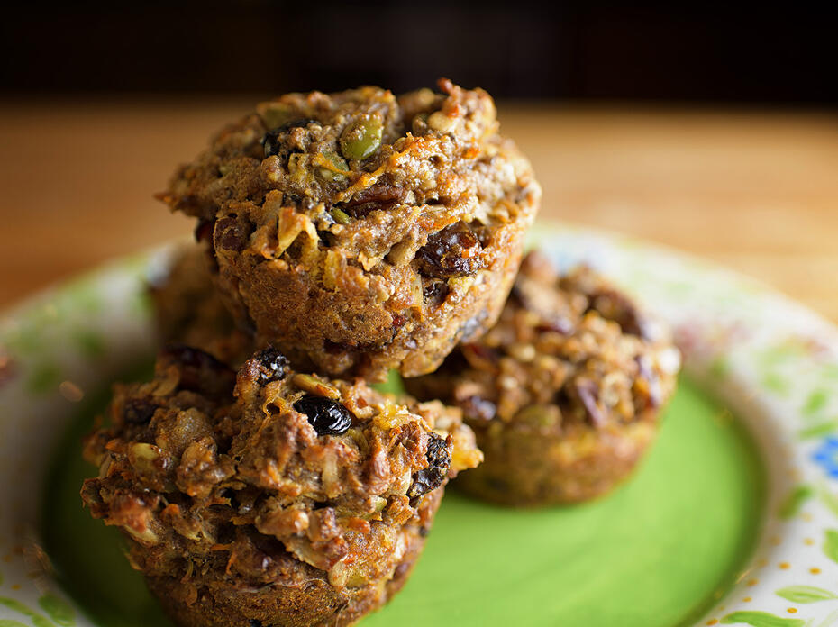Five baked muffins loaded with fruit and nuts on a green floral plate. (Photo by MSU Extension Service/Kevin Hudson)