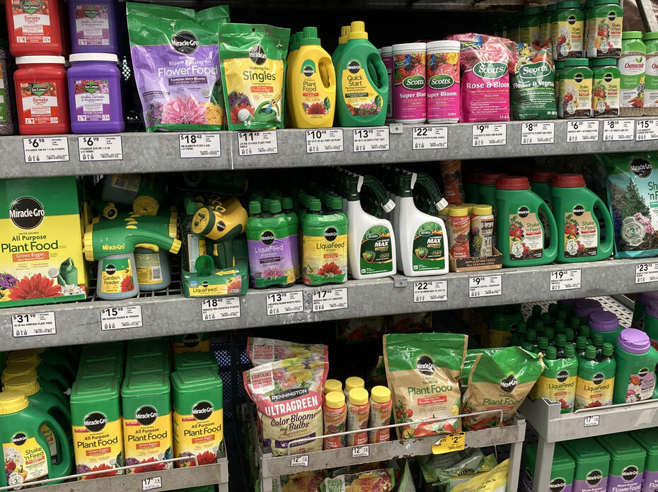 Bottles and bags fill a row of shelves in a store.