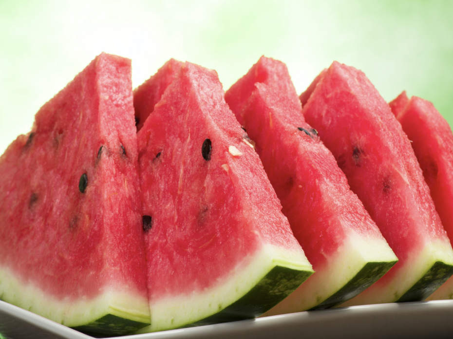 Close up of triangular watermelon slices on a plate.