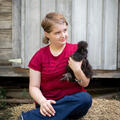 A child holding a chicken.