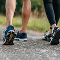 two people walking on a gravel trail