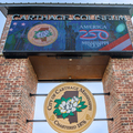 A sign on bricks that lists “Carthage Coliseum,” and “America 250 Mississippi” and shows the City of Carthage seal with a magnolia bloom in the center.