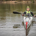 A woman kayaking on the water.