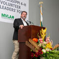 A man standing at a podium with a microphone.
