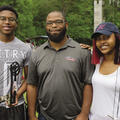A 4-H volunteer leader with two 4-H members at a 4-H Shooting Sports event.