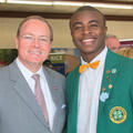 MSU President Mark Keenum stands next to a young man in a green 4-H blazer.
