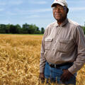 A man standing in a soybean field.
