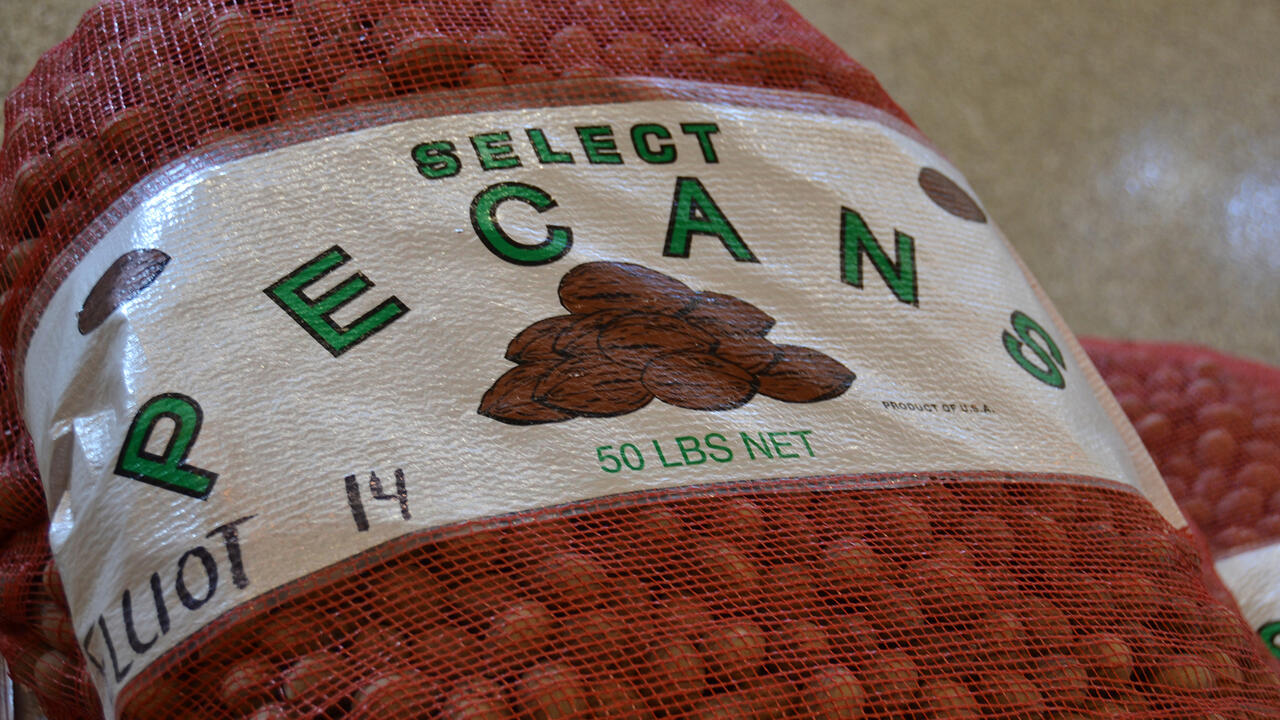 A closeup of a label on a 50-pound bag of in-shell pecans.