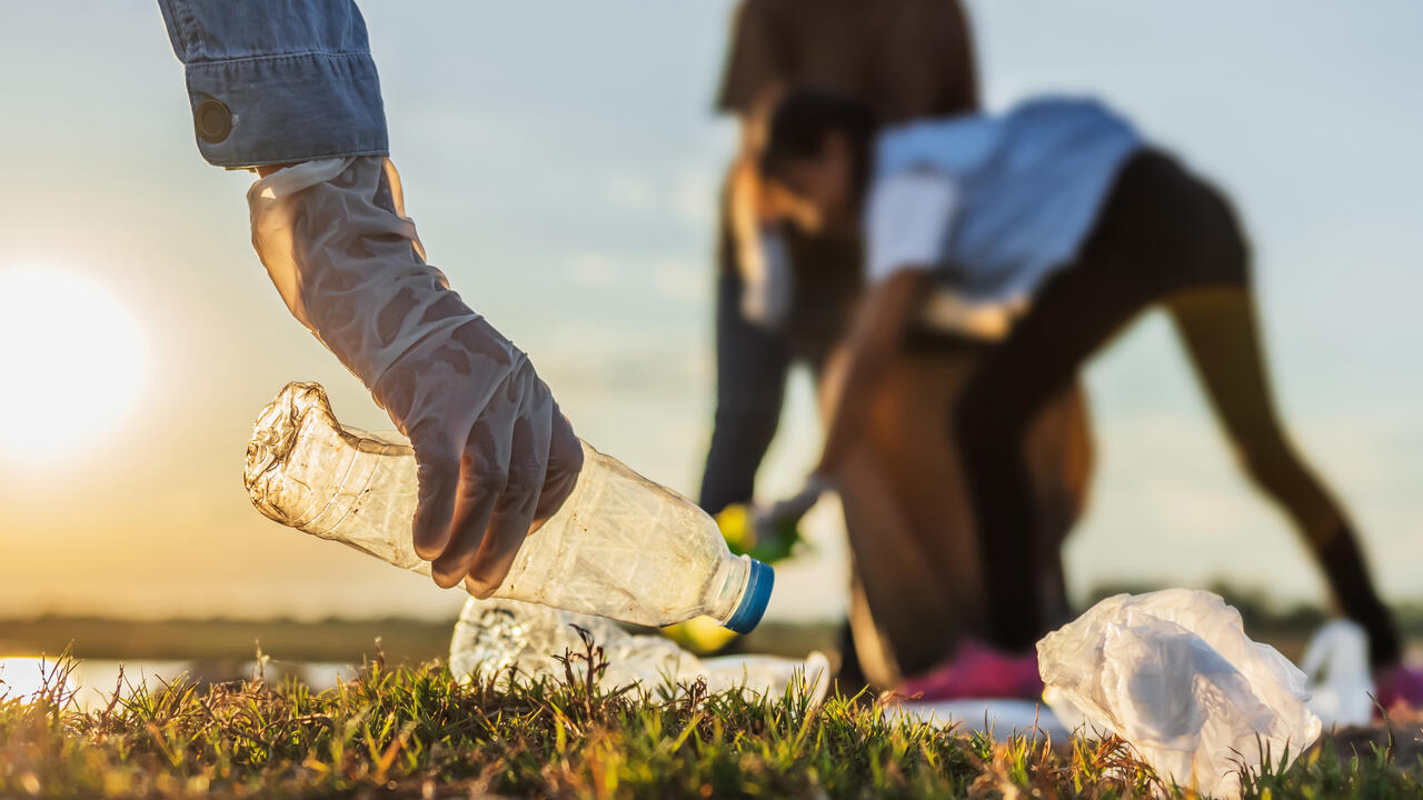 Person picking up trash.
