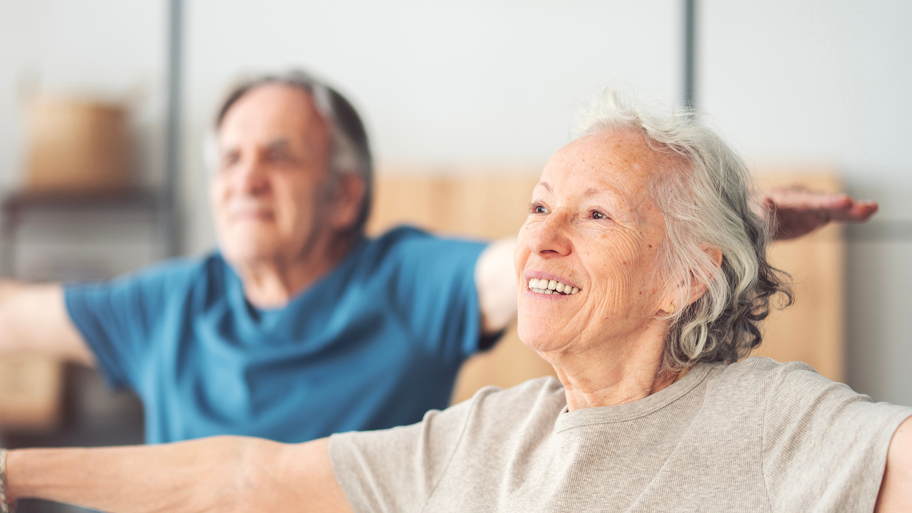 Photo of two people exercising.
