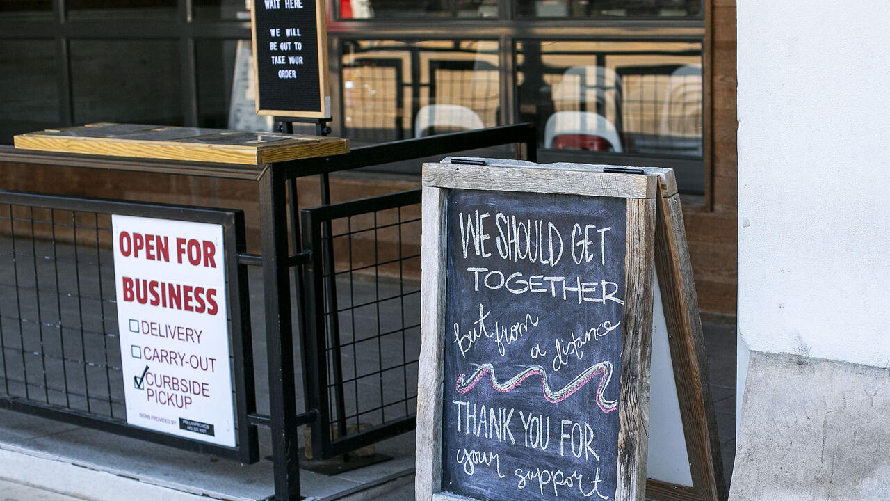 Signs with instructions for ordering curbside greet customers at a local coffee shop 