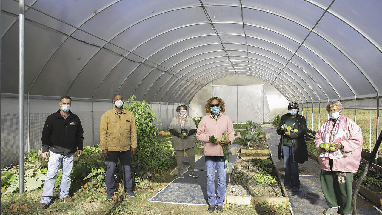 People stand in a garden.