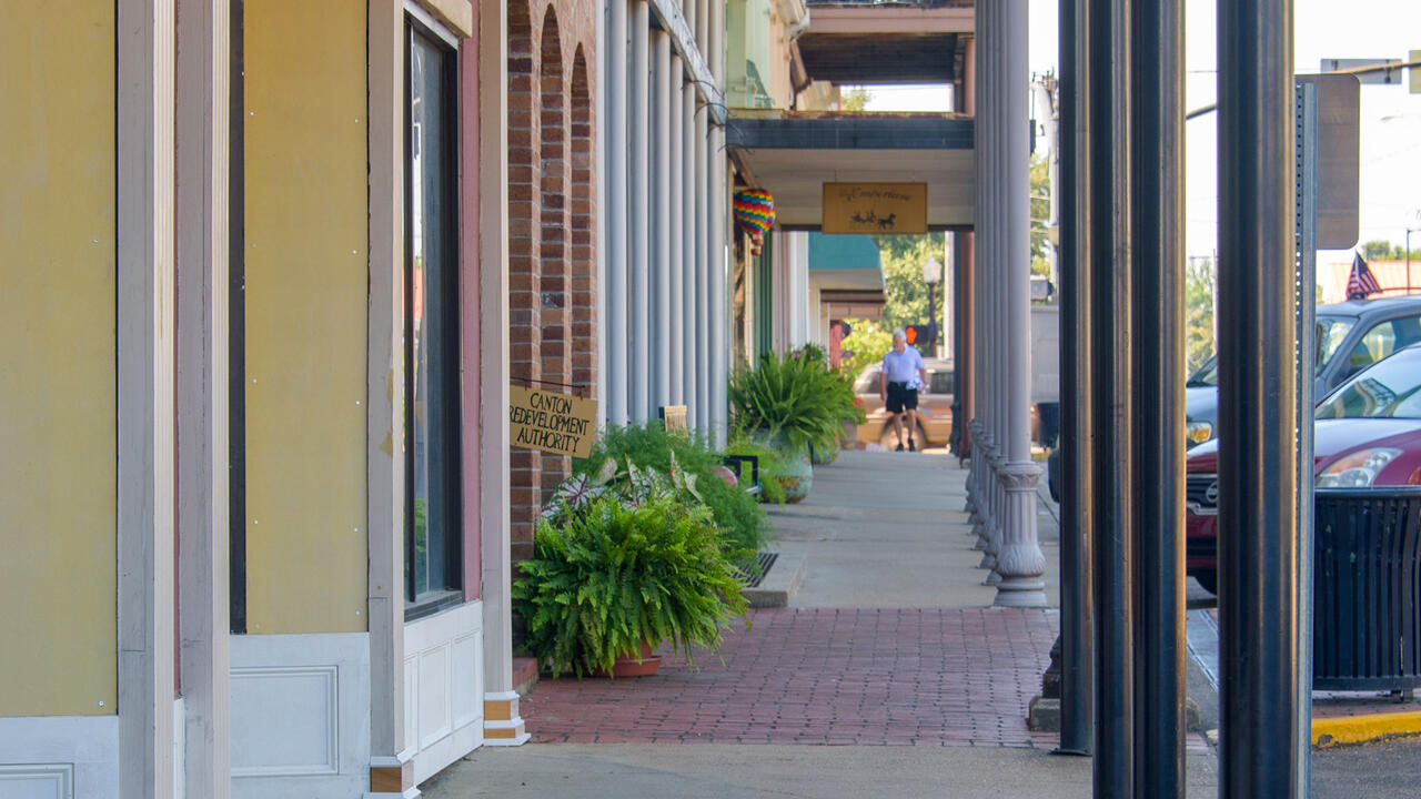 A view down a covered downtown sidewalk.