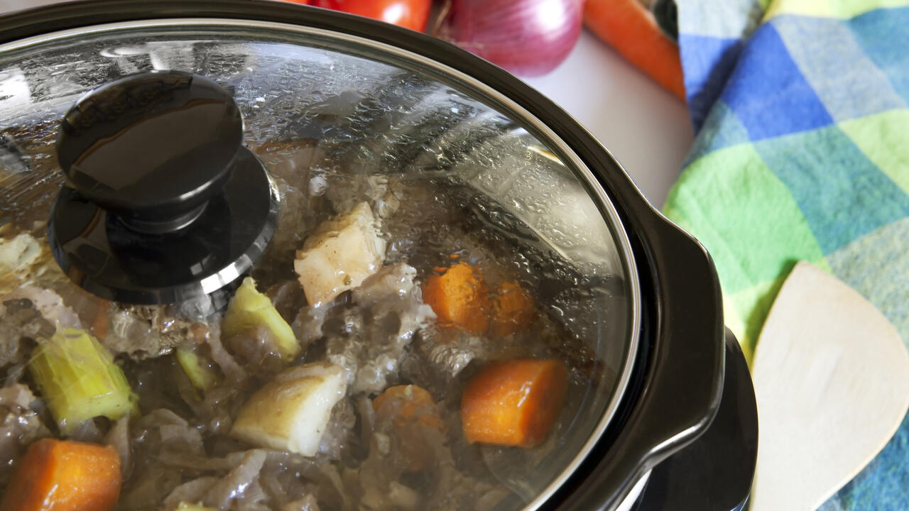 A slow cooker filled with food.