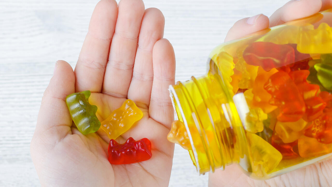 Closeup of gummy vitamins in a child’s hand