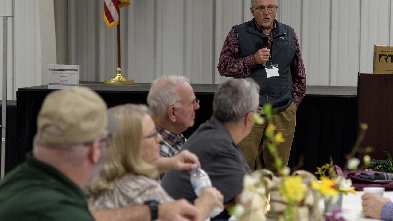 A group of people listen to a public speaker.
