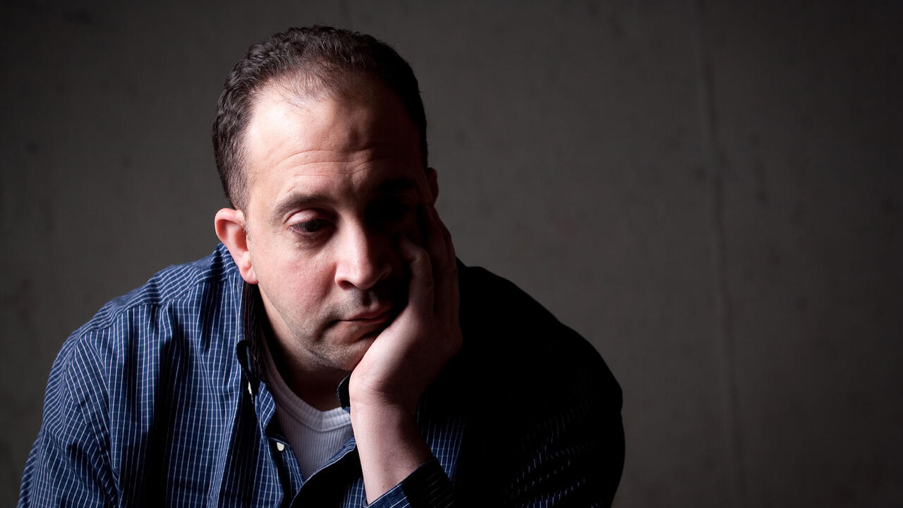 Stressed-out man with head in his hands.