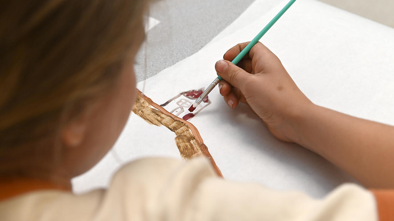 A child paints a picture.