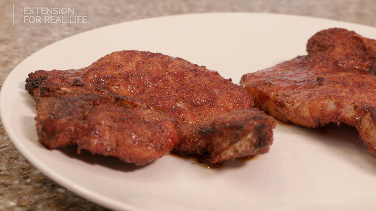 Cooked pork chops on a plate.