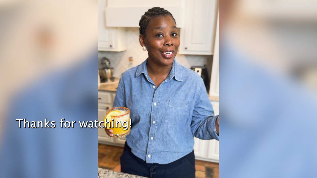 A woman stands in a kitchen.