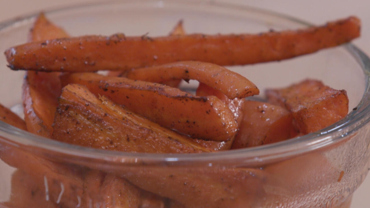 Oven-roasted carrots in a clear glass bowl