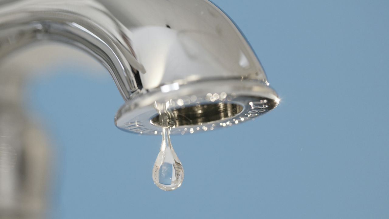 A faucet drips water.
