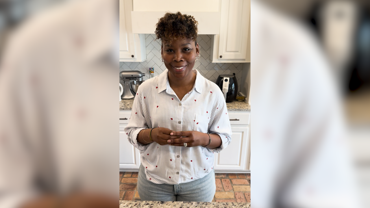 A woman stands in a kitchen.