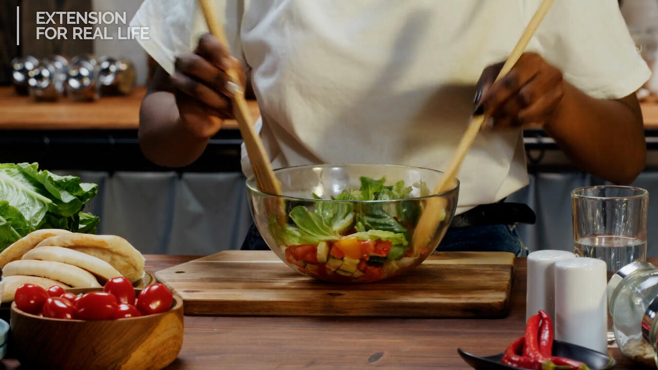 Woman tossing salad