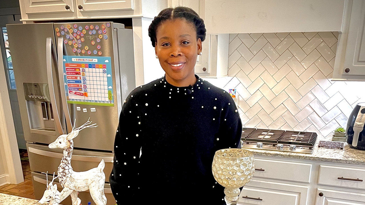 A woman stands in a kitchen