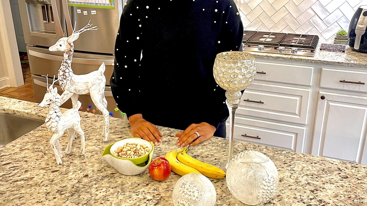 A woman stands in a kitchen