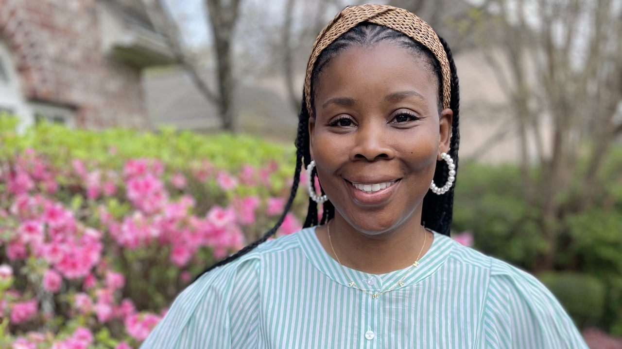 A woman stands outside