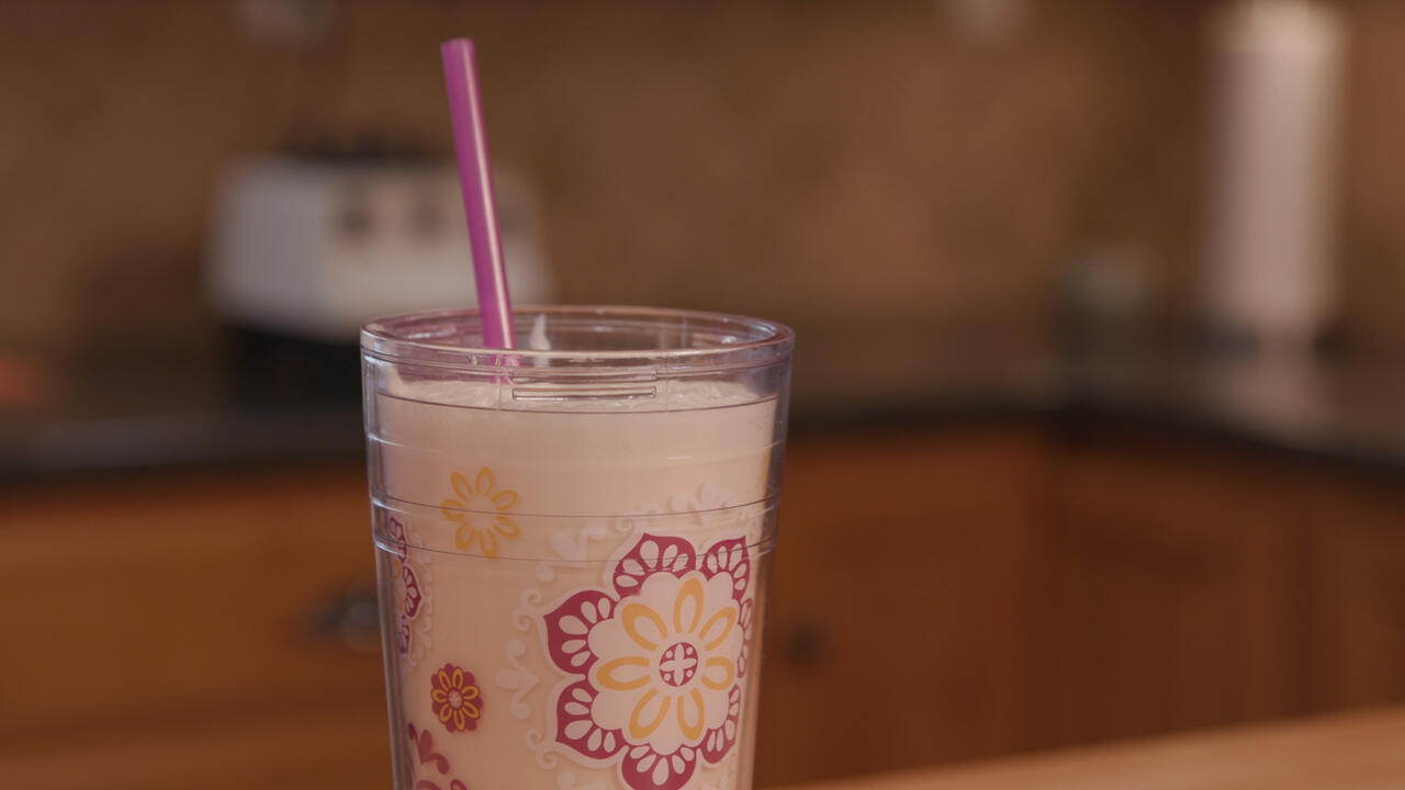 A cup of Orange Delight sits on a counter.