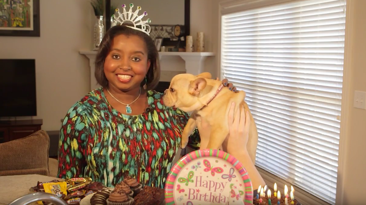 A woman with a dog in front of chocolates, which can make dogs sick.