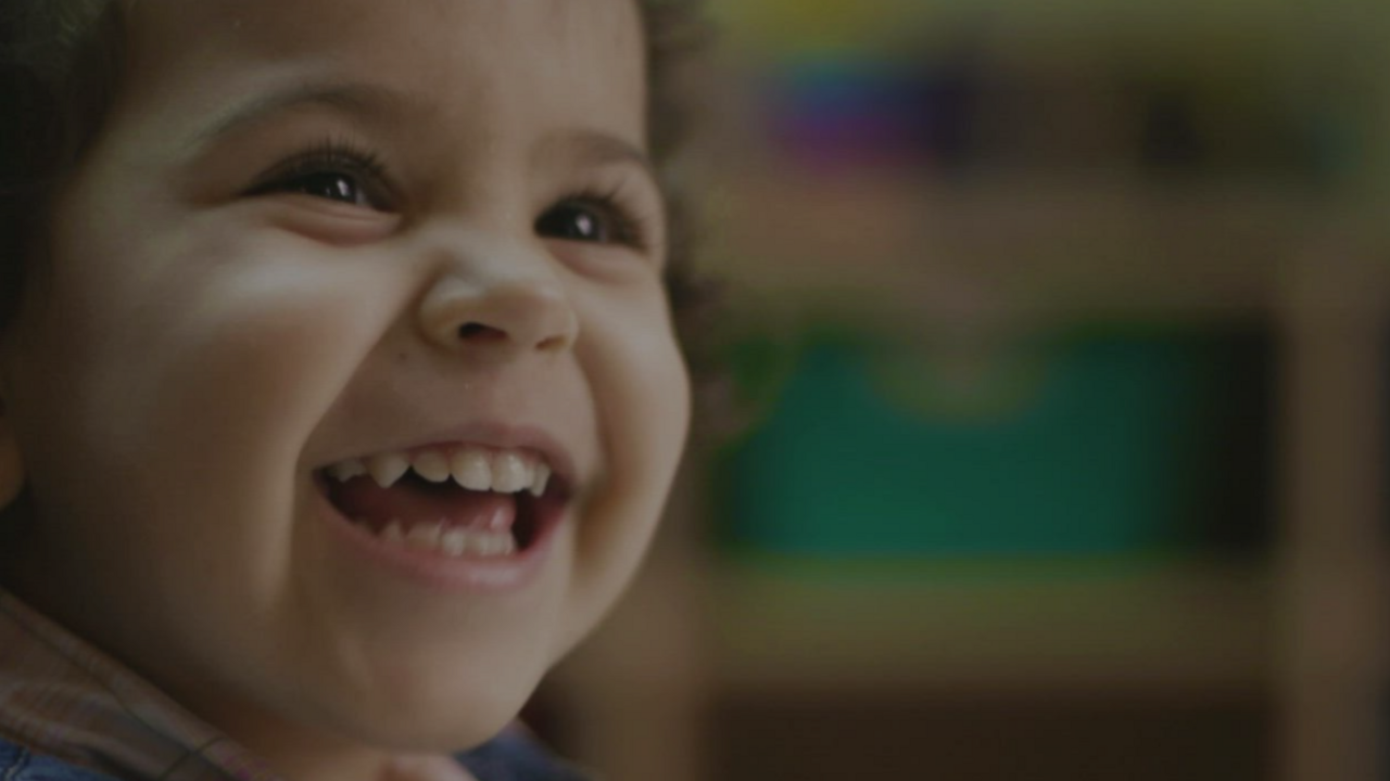 A baby smiling. 