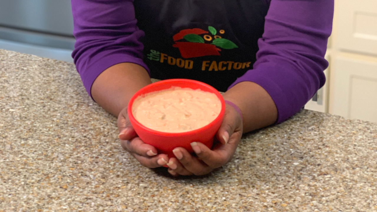 A woman stands in a kitchen.