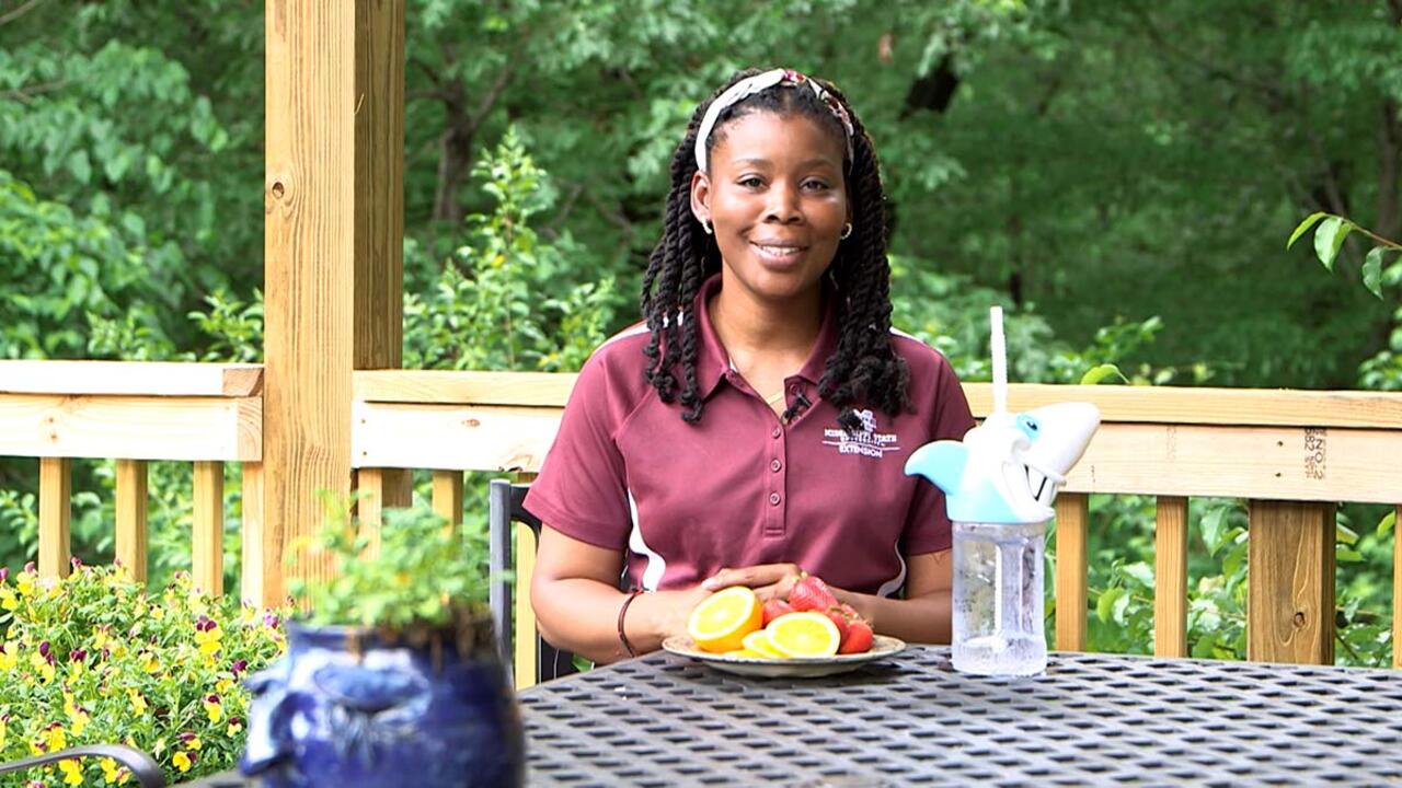 Woman smiling at a table.