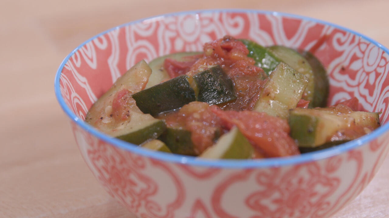 Zucchini and tomatoes in a colorful bowl