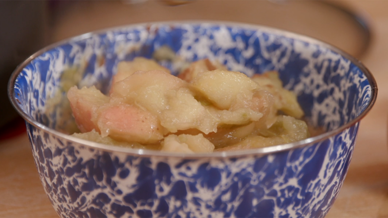 Homemade applesauce in a blue and white enamel bowl.
