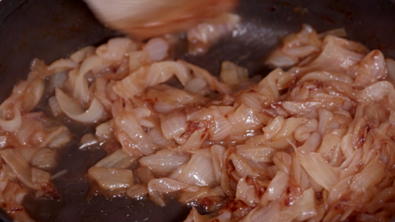 Caramelized onions in a black cast iron skillet.