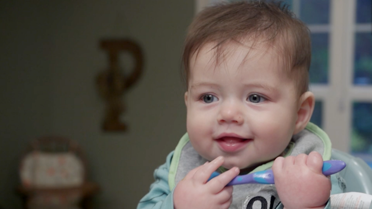 A 10-month-old baby eats homemade baby food.